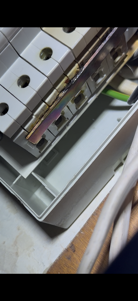 Burn damage on a consumer unit busbar — a dangerous C1 fault
